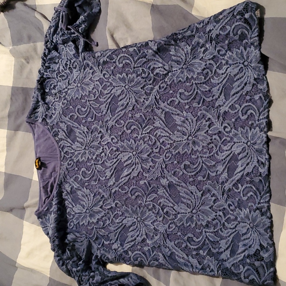 Navy blue laced blouse with blue top underneath.